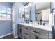Modern bathroom features double sinks, gray cabinetry, and updated fixtures at 10198 Tintinhull Dr, Fort Mill, SC 29707