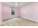 Clean bedroom with a window providing natural light and carpeted floors at 10198 Tintinhull Dr, Fort Mill, SC 29707