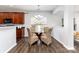Cozy dining area features a glass table, four wicker chairs, and modern chandelier lighting at 10198 Tintinhull Dr, Fort Mill, SC 29707