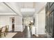 Bright foyer with dark wood flooring, white trim, tall ceilings, and open access to the dining room and main living area at 10198 Tintinhull Dr, Fort Mill, SC 29707