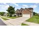 Charming brick home with a two-car garage and inviting curb appeal with landscaped front yard and front porch at 10198 Tintinhull Dr, Fort Mill, SC 29707