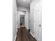 Hallway with wood floors, neutral paint, and multiple doors at 10198 Tintinhull Dr, Fort Mill, SC 29707