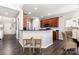 Cozy kitchen with dark wood cabinets, a breakfast bar, and an adjacent dining area for casual meals and gatherings at 10198 Tintinhull Dr, Fort Mill, SC 29707