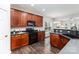 Functional kitchen featuring wood cabinetry, modern appliances, and plenty of counter space at 10198 Tintinhull Dr, Fort Mill, SC 29707