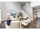 Inviting living room featuring a cozy seating area, elegant decor, and a staircase leading to the upper level at 10198 Tintinhull Dr, Fort Mill, SC 29707