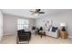 Bright living room with modern sofa, accent pillows, stylish decor, and a ceiling fan at 10198 Tintinhull Dr, Fort Mill, SC 29707
