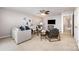Cozy living area with plush seating, ceiling fan, and mounted TV, perfect for relaxing at 10198 Tintinhull Dr, Fort Mill, SC 29707