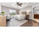 A spacious main bedroom with a tray ceiling, ceiling fan, and luxury finishes at 10198 Tintinhull Dr, Fort Mill, SC 29707
