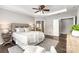 A spacious main bedroom with a tray ceiling, ceiling fan, and luxury finishes at 10198 Tintinhull Dr, Fort Mill, SC 29707