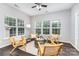 Bright sunroom with large windows, hardwood floors, and comfortable seating area at 10198 Tintinhull Dr, Fort Mill, SC 29707