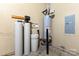 Utility room shows water filtration system, water heater, and electrical panel against a neutral wall at 10198 Tintinhull Dr, Fort Mill, SC 29707