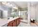 Bathroom with double vanity, marble shower, and modern fixtures in neutral tones at 10198 Tintinhull Dr, Indian Land, SC 29707