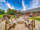 Backyard patio area with a cozy stone fire pit, seating, and string lights, perfect for outdoor relaxation and entertainment at 1060 S Lentz Harness Shop Rd, Mount Pleasant, NC 28124