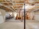 Large unfinished basement space showing wood frame staircase and ample space for storage at 1060 S Lentz Harness Shop Rd, Mount Pleasant, NC 28124