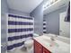 Contemporary bathroom with a shower, toilet, and vanity, with a striped shower curtain adding a modern touch at 1060 S Lentz Harness Shop Rd, Mount Pleasant, NC 28124