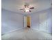 Bright and spacious bedroom with carpet and a ceiling fan, illuminated by natural light from two windows at 1060 S Lentz Harness Shop Rd, Mount Pleasant, NC 28124