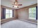 Spacious bedroom featuring a large window, carpeted flooring, and neutral walls creating a cozy living area at 1060 S Lentz Harness Shop Rd, Mount Pleasant, NC 28124
