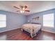 Inviting bedroom with hardwood floors, ceiling fan, and a queen bed exudes comfort and relaxation at 1060 S Lentz Harness Shop Rd, Mount Pleasant, NC 28124