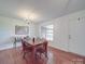 Bright dining room with hardwood floors, wooden table, chandelier, and view to the deck through the large window at 1060 S Lentz Harness Shop Rd, Mount Pleasant, NC 28124
