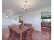 Inviting dining room with wood table, chandelier, and hardwood floors, perfect for Gathering meals and gatherings at 1060 S Lentz Harness Shop Rd, Mount Pleasant, NC 28124