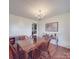 Bright dining room featuring a wooden table, chandelier, and picture, complemented by hardwood floors and natural light at 1060 S Lentz Harness Shop Rd, Mount Pleasant, NC 28124