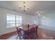 Inviting dining area with hardwood floors, six-chair wooden table, and bright windows to bring in the light at 1060 S Lentz Harness Shop Rd, Mount Pleasant, NC 28124