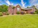Beautiful exterior of the home featuring a well-manicured lawn and mature landscaping at 1060 S Lentz Harness Shop Rd, Mount Pleasant, NC 28124