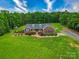 Beautiful front exterior of the home featuring a well-manicured lawn and a cozy front porch at 1060 S Lentz Harness Shop Rd, Mount Pleasant, NC 28124