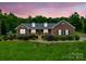 Charming brick home featuring a well-manicured lawn and a cozy front porch at 1060 S Lentz Harness Shop Rd, Mount Pleasant, NC 28124