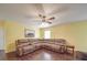 Comfortable living room featuring a large sectional sofa, ceiling fan, and warm yellow walls at 1060 S Lentz Harness Shop Rd, Mount Pleasant, NC 28124