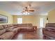 Relaxing living room with a large sectional, a ceiling fan, a side table, and a comfortable recliner at 1060 S Lentz Harness Shop Rd, Mount Pleasant, NC 28124