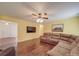 Spacious living room with large sectional sofa, ceiling fan, and a mounted TV for entertainment at 1060 S Lentz Harness Shop Rd, Mount Pleasant, NC 28124