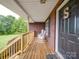 Inviting front porch with rocking chairs, brick exterior, and wooden railing detail creating a cozy entrance at 1060 S Lentz Harness Shop Rd, Mount Pleasant, NC 28124