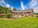 Beautiful home featuring a large backyard with patio, fire pit, and lush landscaping at 1060 S Lentz Harness Shop Rd, Mount Pleasant, NC 28124