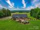 Aerial view of a beautiful home featuring a large backyard and covered patio at 1060 S Lentz Harness Shop Rd, Mount Pleasant, NC 28124