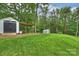 Lush backyard with a shed and covered storage area, perfect for outdoor activities and storage at 1119 Thornsby Ln, Matthews, NC 28105