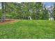 Well-manicured backyard with a storage shed, fenced perimeter, and lush green lawn at 1119 Thornsby Ln, Matthews, NC 28105