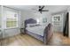Cozy bedroom with a unique headboard and plenty of natural light at 1119 Thornsby Ln, Matthews, NC 28105