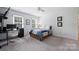 Bedroom with a desk, ceiling fan, two windows, and a bed with storage drawers underneath at 1119 Thornsby Ln, Matthews, NC 28105