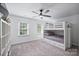 Bedroom features a bunk bed, two windows, neutral carpet, ceiling fan, and a bookshelf at 1119 Thornsby Ln, Matthews, NC 28105
