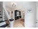 Inviting foyer with hardwood floors, a staircase, and view into the living spaces at 1119 Thornsby Ln, Matthews, NC 28105