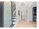 Bright foyer with hardwood floors, staircase, and decorative glass front door at 1119 Thornsby Ln, Matthews, NC 28105