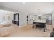 Open-concept kitchen with island seating and adjacent living space featuring a fireplace at 1119 Thornsby Ln, Matthews, NC 28105