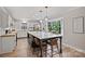 Bright kitchen with island seating, quartz countertops, stainless appliances, and view from the bay window at 1119 Thornsby Ln, Matthews, NC 28105