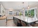 Bright kitchen featuring an island with bar seating, stainless steel appliances, and large windows at 1119 Thornsby Ln, Matthews, NC 28105