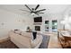 Bright living room with a ceiling fan, a fireplace, and access to the back deck at 1119 Thornsby Ln, Matthews, NC 28105