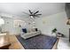 Spacious living room with a large ceiling fan and a decorative area rug at 1119 Thornsby Ln, Matthews, NC 28105