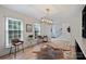 Bright living room featuring hardwood floors, natural light, and a modern light fixture at 1119 Thornsby Ln, Matthews, NC 28105