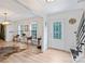 Open-concept living room with hardwood floors, natural light, and a stylish area rug at 1119 Thornsby Ln, Matthews, NC 28105