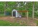 Outdoor storage shed with an attached covered structure, perfect for gardening or storage needs at 1119 Thornsby Ln, Matthews, NC 28105